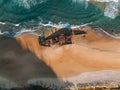 K'gari High angle aerial bird's eye drone view of the Maheno shipwreck on Seventy-Five Mile Beach on Fraser