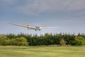 K21 Glider landing across trees Royalty Free Stock Photo