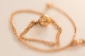 18K golden ball necklace on white closeup Royalty Free Stock Photo