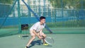 4K. The guy is a tennis player with a racket and a ball, the man is preparing to hit the ball with a racket Royalty Free Stock Photo