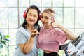 Happy Asian daughter and elderly mother in sportswear exercise together at home both of them smiled happily. Retired woman Royalty Free Stock Photo