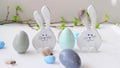 4K.Happy easter. Decorative wooden eggs and funny bunnys on grey background. Festive decoration. Holiday concept