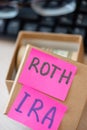 401k ira roth on pieces of colorful paper dollars on table. Pension concept. Retirement plans