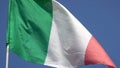 4K. Italian flag waving in the wind on a blue sky. Italy flag