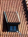 Older brick roof with roof dormer and `monk and nun` - roof tile Royalty Free Stock Photo
