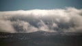 8K Mist Cloud Flowing Down Ridge of Mountain Range