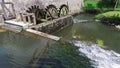 4K. Old water mill still working. Wooden wheels of old mill are rotating. Postojna Cave, Slovenia, Europe