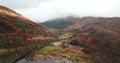 4k aerial footage of Glenfinnan viaduct, monument, Loch Shiel and mountains in Autumn