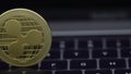 4K Physical metal golden Ripplecoin currency on notebook computer keyboard.