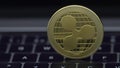 4K Physical metal golden Ripplecoin currency on notebook computer keyboard.