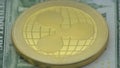 4K Physical metal golden Ripplecoin currency over diferents dollars bills