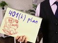 401k plan on a sheet of notebook in the hands of a man. Papers with 401k plan Royalty Free Stock Photo