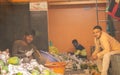 K.R.Market, Bangalore, India - February 06,2021: Hindu and Muslim pineapple sellers showing victory symbol