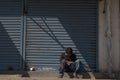 K.R.Market, Bangalore, India - February 06,2021: Person sitting in Diagonal shadows in the streets