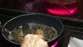 4k Spanish grandma is cooking a croquettes in pan with olive oil of a kichen