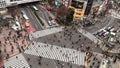 4K UHD Aerial view time-lapse of Shibuya zebra crossing with crowded people and car traffic transport across intersection