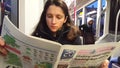 4K UHD video of morning reading newspaper in metropolitan tram.