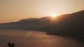 4k video. Beautiful sunrise over huge mountain ridge on greek island. Tranquile seascape of Ionian Sea in the morning