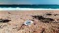 4k video of plastic cup, gardbage and debris lying on th esea beach. Concept of pollution and nature disaster
