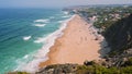 4K view of at Praia Grande beach and rugged bizarre rocky cliffs and ocena waves. Portugal. Travel and recreation