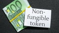 4k zoom in out NFT non-fungible token text. Concept words NFT non-fungible token on paper blank. Background of euro