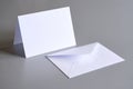 Empty rectangular greeting card and envelope mock up on clean grey background