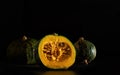 Kabocha pumpkins over a black background.