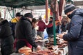 KACAREVO, SERBIA - MARCH 6, 2022: Selective blur on a Couple of butchers selliing smoked & cured meat, sausage, kosasica style, to