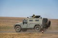 Armored car GAZ-233014 Tiger with a machine gunner upstairs quickly goes on a military training ground