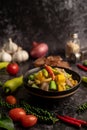 Kaeng Liang in a bowl with spices on a black cement floor