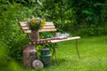 Old painted milk jugs on a garden bench Royalty Free Stock Photo