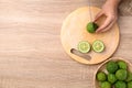 Kaffir lime cutting on wooden board, Table top view Royalty Free Stock Photo
