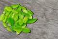 Kaffir lime herbal leaves on vintage grunge wooden background