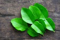 Kaffir lime leaves on wooden background from the tree - bergamot leaf