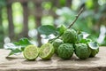 Kaffir lime with leaves on wooden background.