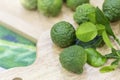 Kaffir lime leaves, kaffir lime leaves on a wooden cutting board in the kitchen. Kaffir lime leaves on a kitchen cutting board Royalty Free Stock Photo