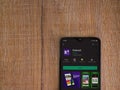 Kahoot! app play store page on the display of a black mobile smartphone on wooden background