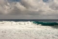 White surf of dark ocean turning azure wave on Kaimu Beach, Hawaii, USA Royalty Free Stock Photo