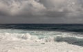 Dark ocean turns into white surf under heavy cloudscape on Kaimu Beach, Hawaii, USA Royalty Free Stock Photo