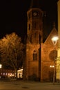 Light shining on tree next to church at night Royalty Free Stock Photo