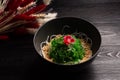 Kaiso with nut sauce and sesame on a wooden background