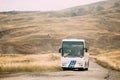 Kakheti Region, Georgia - Bus With Tourists Rides On The Gareji Desert On Autumn Landscape Background In Sagarejo