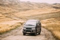 Kakheti Region, Georgia. Mitsubishi Delica Space Gear On Country Road In Gareji Desert On Autumn Landscape Background In