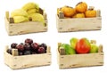 Kaki fruit, bananas, plums and mango`s in a wooden crate Royalty Free Stock Photo