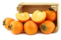 kaki fruit in a wooden box Royalty Free Stock Photo