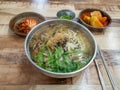 Kal-guksu, a Korean noodle dish consisting of handmade, knife-cut wheat flour noodles served in a large bowl.