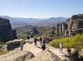 Kalabaka, Greece. April 2022: Tourists and Panoramic view of the Meteora Mountains and the Rusanou Monastery from the observation