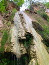 Kalamaris waterfall and small emerald lake among steep banks. Royalty Free Stock Photo