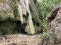 Kalamaris waterfall and small emerald lake among steep banks Royalty Free Stock Photo
