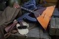 Kalashnikov AK 47 with ammunitions and balalaika on army box background Royalty Free Stock Photo